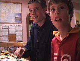 Lee and James play Monopoly with another hosteller at Lynton youth hostel after supper